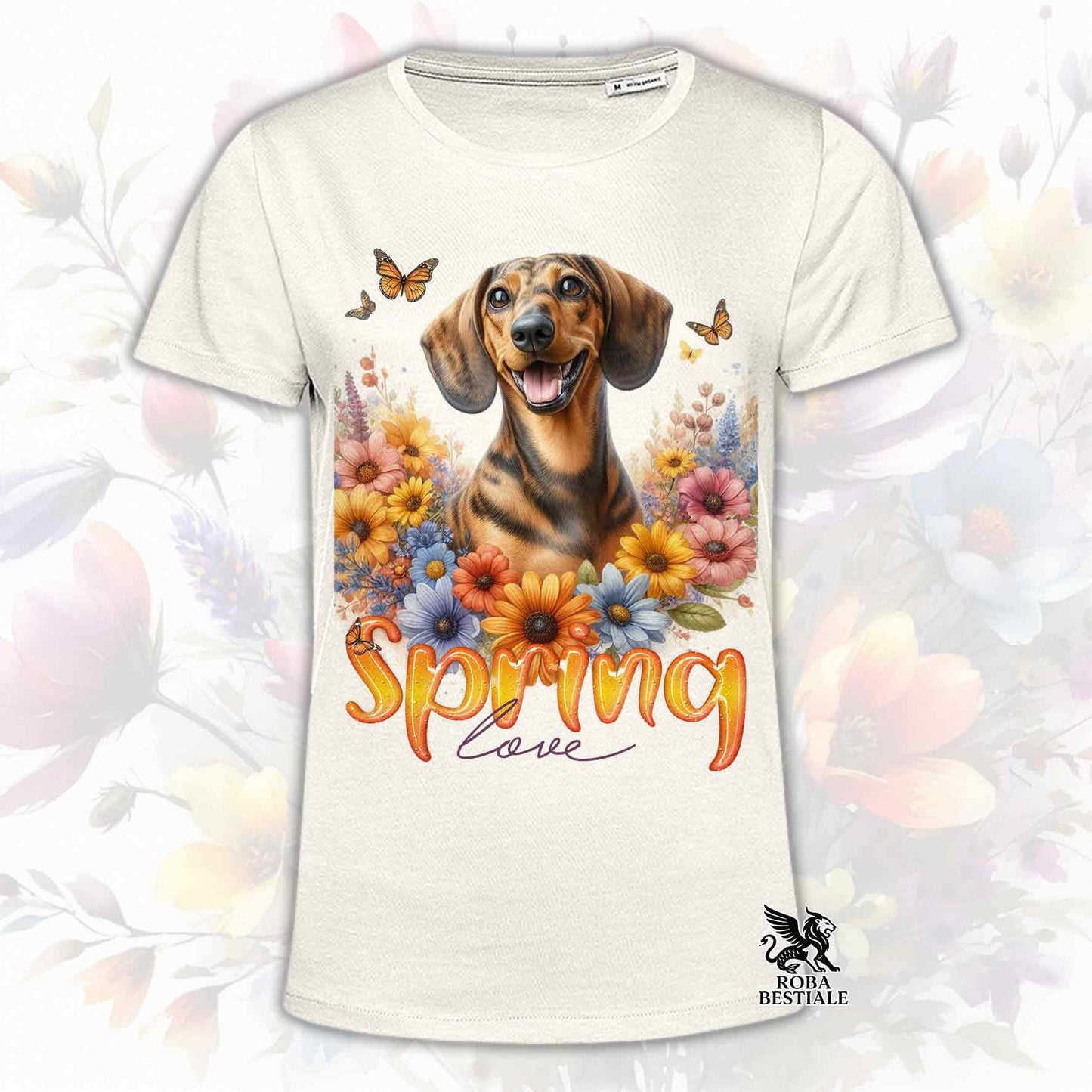 Una t-shirt beige stampata con un Bassotto a pelo corto immerso nei fiori colorati. Collezione Spring Love di Roba Bestiale