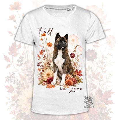 T-shirt bianca stampata con un Akita Americano seduto in mezzo a fiori e foglie autunnali. Grafica originale Roba Bestiale, collezione Fall
