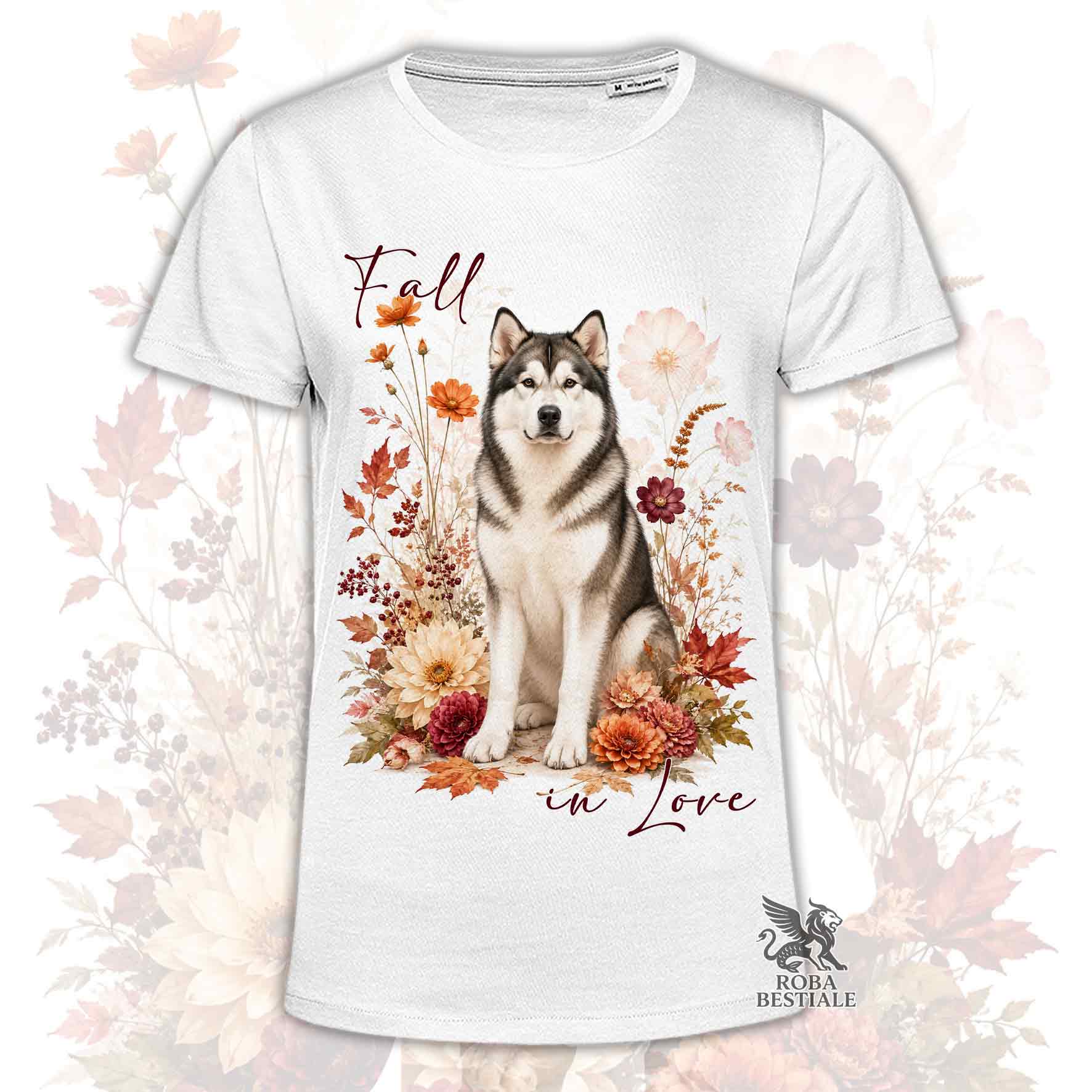 T-shirt bianca stampata con un Alaskan Malamute seduto in mezzo a fiori e foglie autunnali. Grafica originale Roba Bestiale, collezione Fall