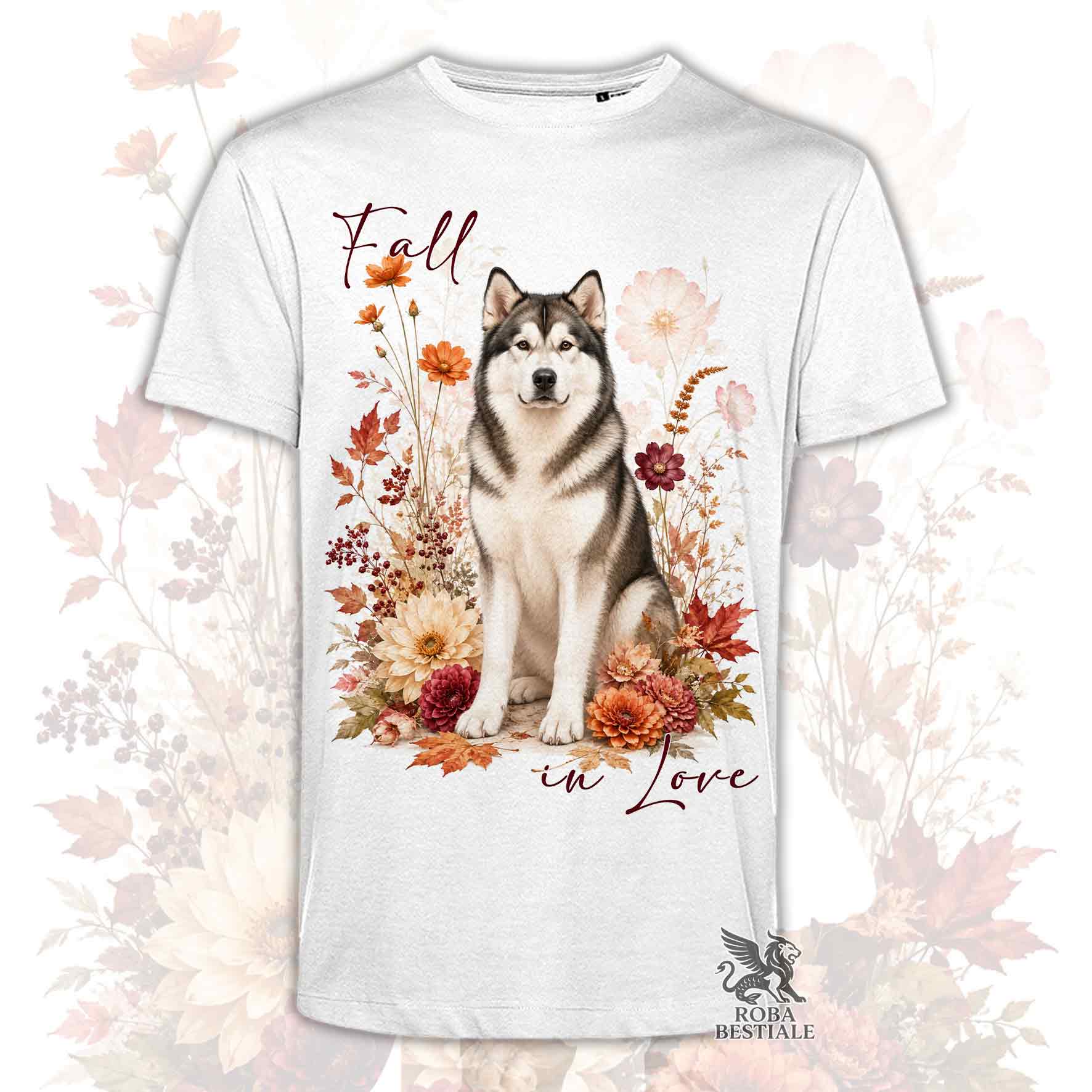 T-shirt bianca stampata con un Alaskan Malamute seduto in mezzo a fiori e foglie autunnali. Grafica originale Roba Bestiale, collezione Fall