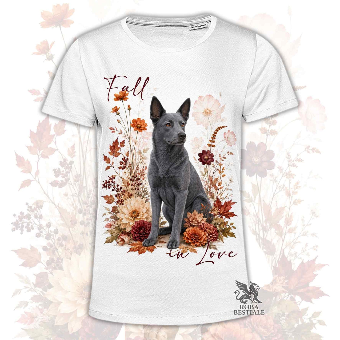 T-shirt bianca stampata con un Australian Kelpie seduto in mezzo a fiori e foglie autunnali. Grafica originale Roba Bestiale, collezione Fall