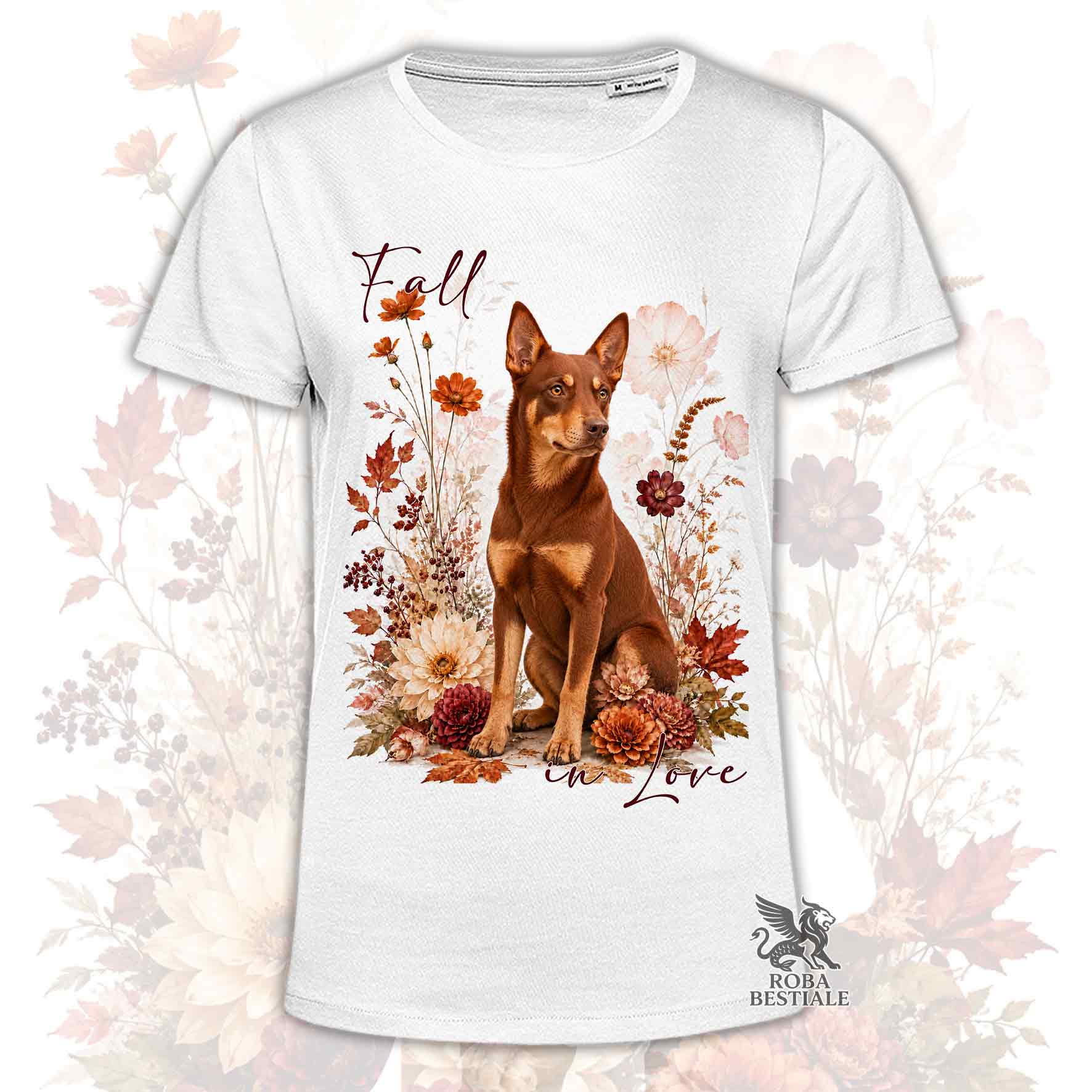 T-shirt bianca stampata con un Australian Kelpie seduto in mezzo a fiori e foglie autunnali. Grafica originale Roba Bestiale, collezione Fall