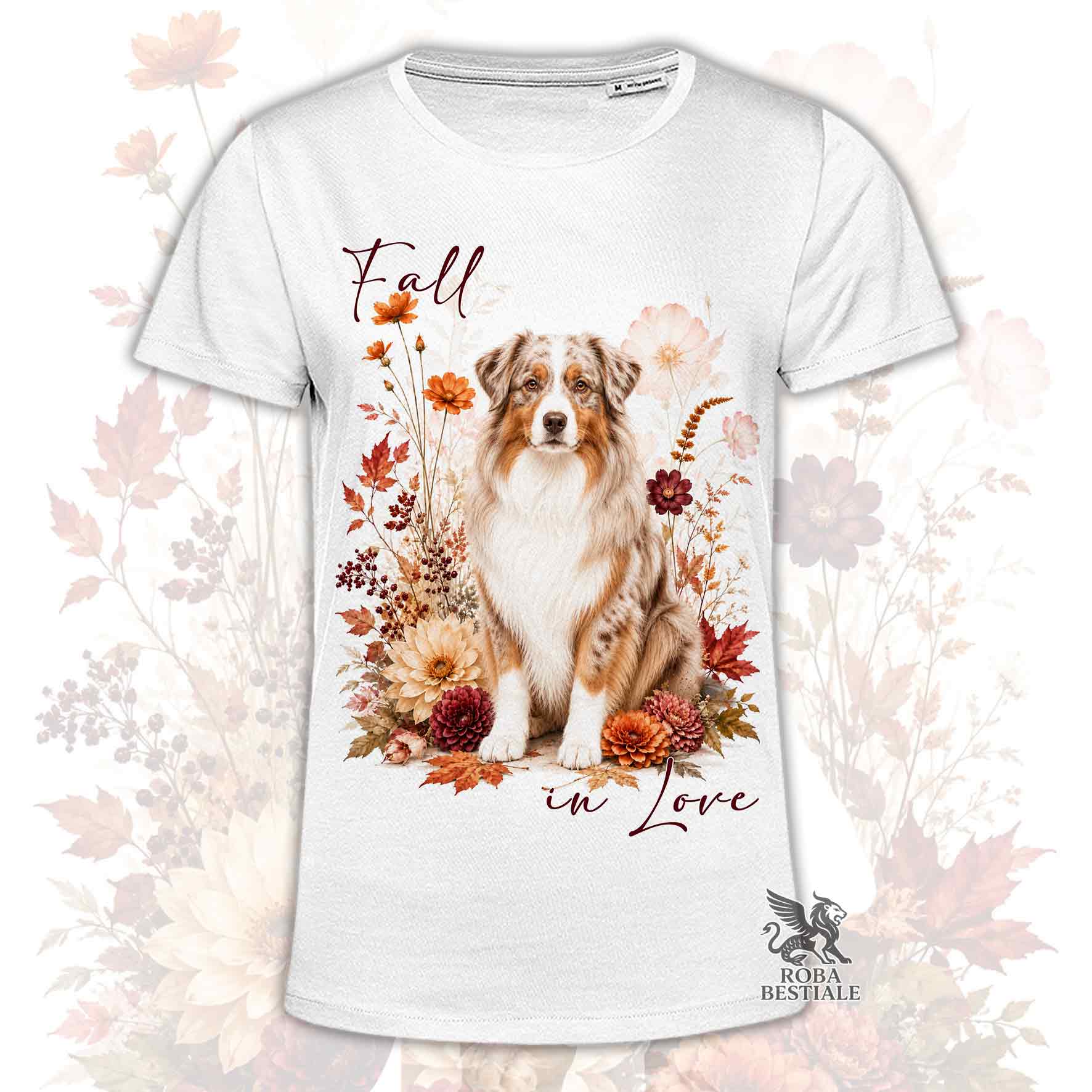 T-shirt bianca stampata con un Australian Shepherd seduto in mezzo a fiori e foglie autunnali. Grafica originale Roba Bestiale, collezione Fall in Love