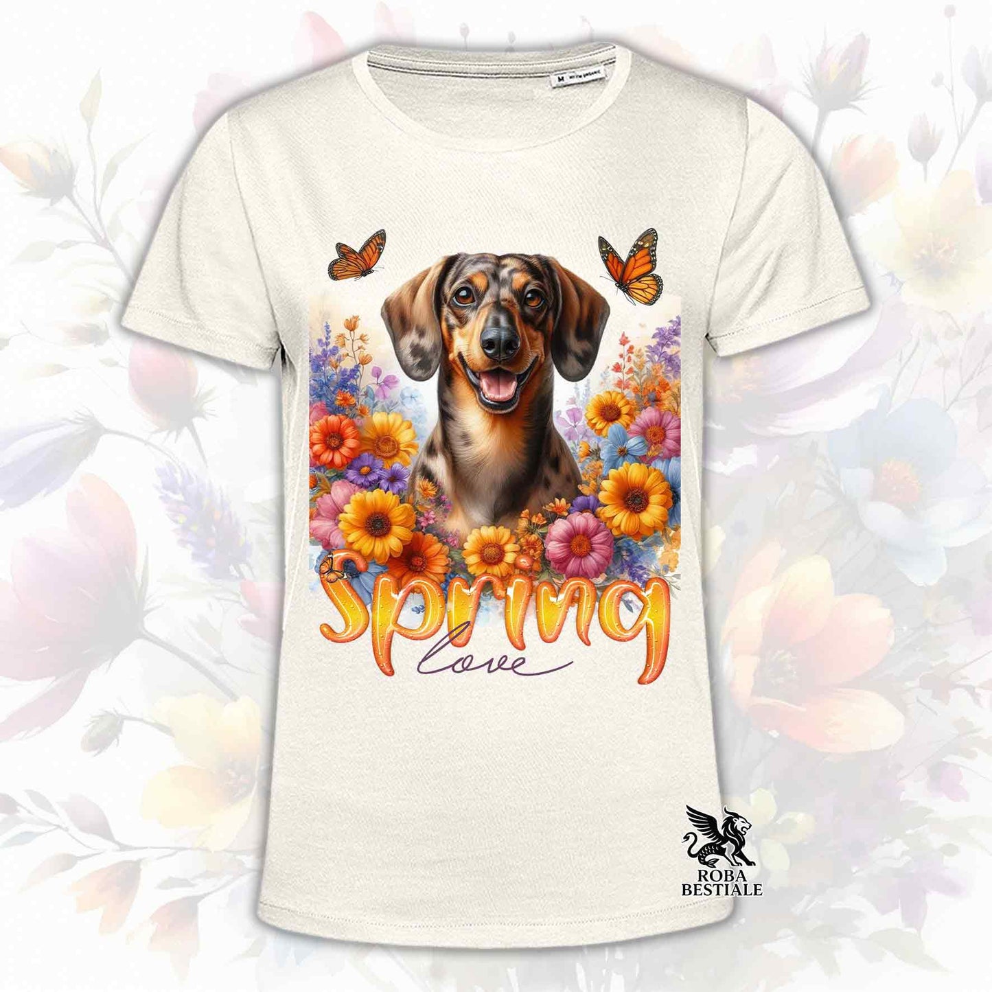 Una t-shirt beige stampata con un Bassotto a pelo corto immerso nei fiori colorati. Collezione Spring Love di Roba Bestiale