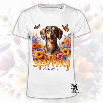 Una t-shirt bianca stampata con un Bassotto a pelo corto immerso nei fiori colorati. Collezione Spring Love di Roba Bestiale