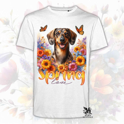 Una t-shirt bianca stampata con un Bassotto a pelo corto immerso nei fiori colorati. Collezione Spring Love di Roba Bestiale