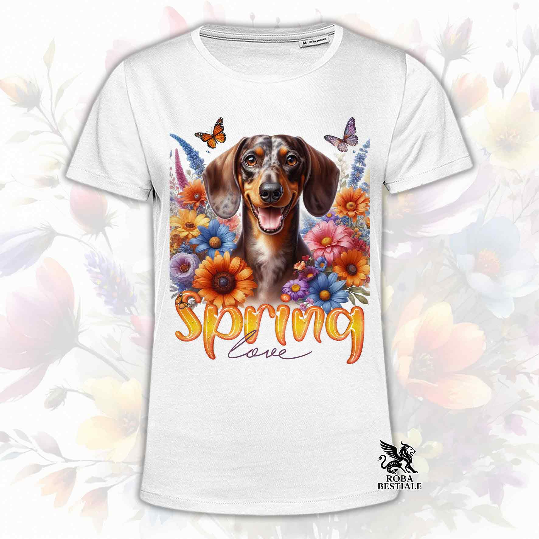 Una t-shirt bianca stampata con un Bassotto a pelo corto immerso nei fiori colorati. Collezione Spring Love di Roba Bestiale