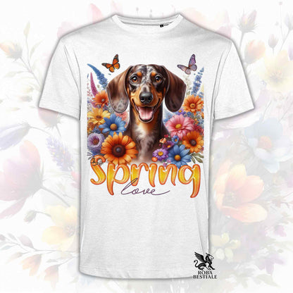 Una t-shirt bianca stampata con un Bassotto a pelo corto immerso nei fiori colorati. Collezione Spring Love di Roba Bestiale