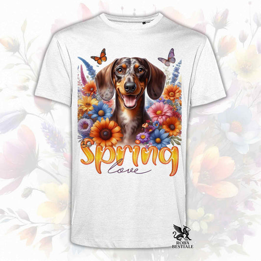 Una t-shirt bianca stampata con un Bassotto a pelo corto immerso nei fiori colorati. Collezione Spring Love di Roba Bestiale