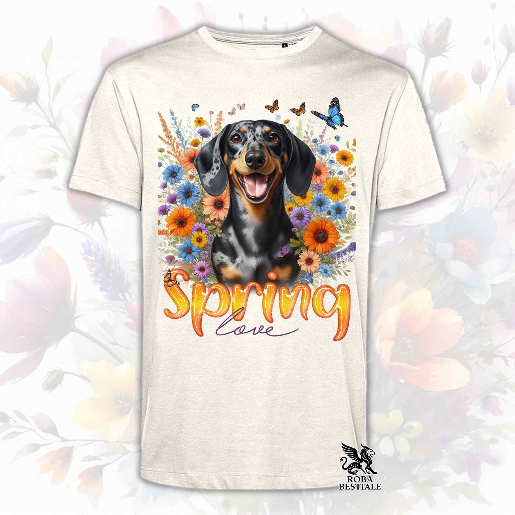 Una t-shirt beige stampata con un Bassotto a pelo corto immerso nei fiori colorati. Collezione Spring Love di Roba Bestiale