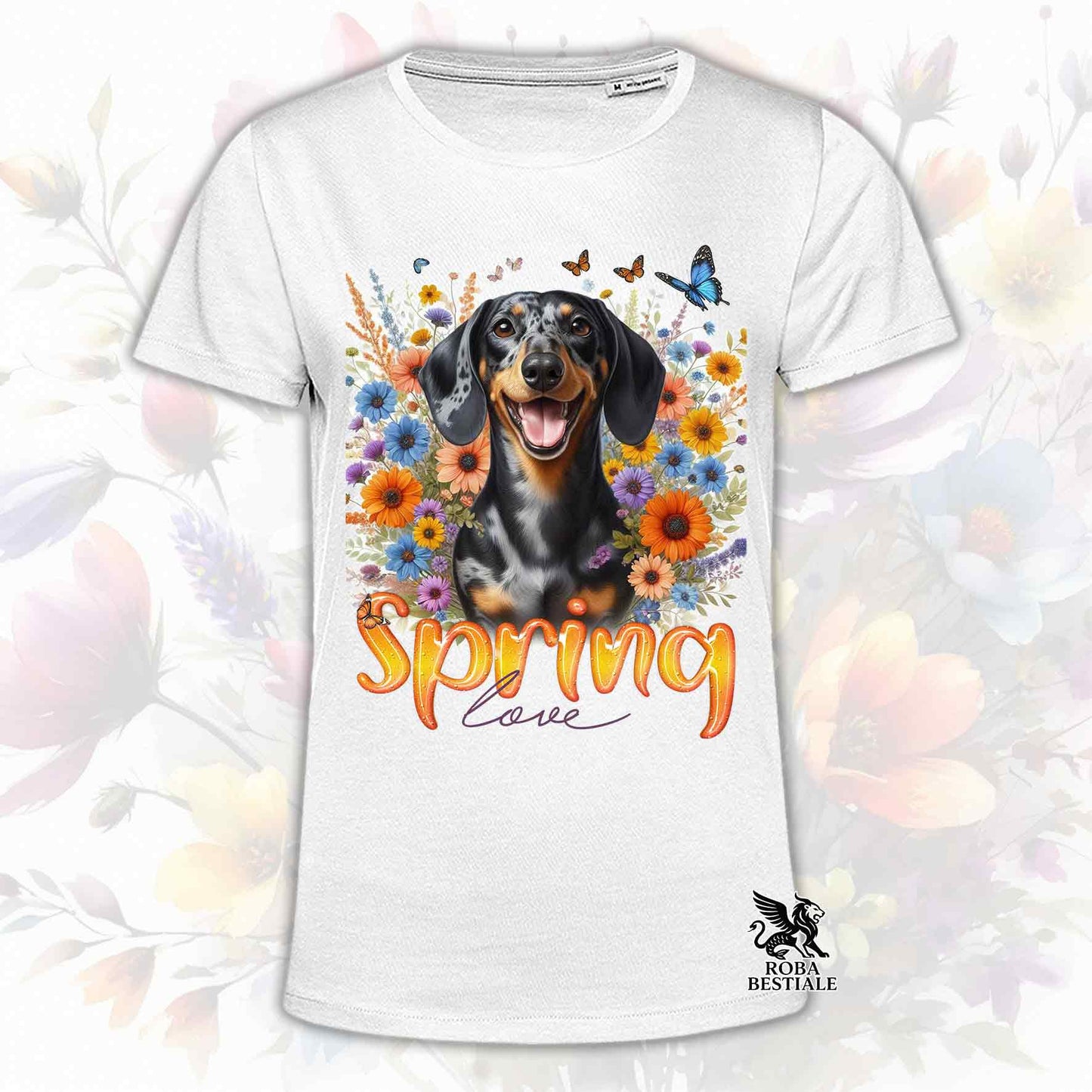 Una t-shirt bianca stampata con un Bassotto a pelo corto immerso nei fiori colorati. Collezione Spring Love di Roba Bestiale