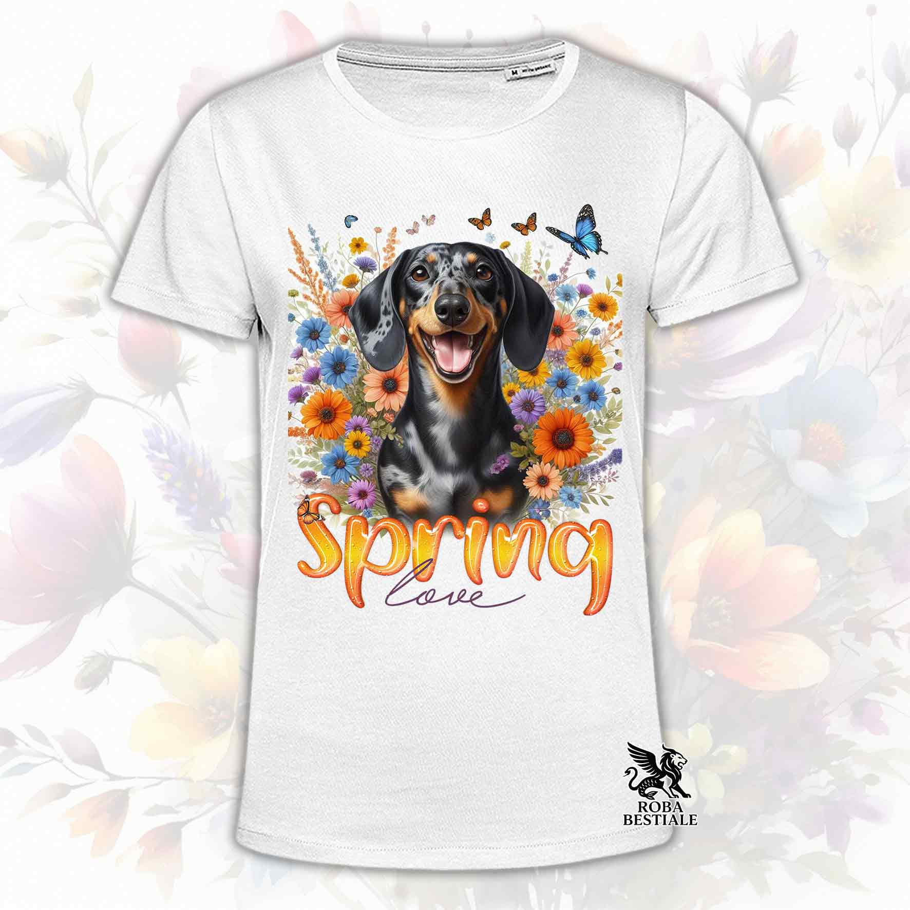 Una t-shirt bianca stampata con un Bassotto a pelo corto immerso nei fiori colorati. Collezione Spring Love di Roba Bestiale