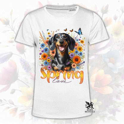 Una t-shirt bianca stampata con un Bassotto a pelo corto immerso nei fiori colorati. Collezione Spring Love di Roba Bestiale