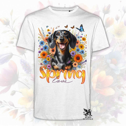 Una t-shirt bianca stampata con un Bassotto a pelo corto immerso nei fiori colorati. Collezione Spring Love di Roba Bestiale