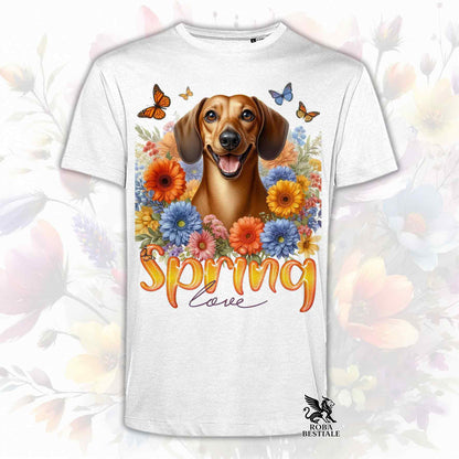 Una t-shirt bianca stampata con un Bassotto a pelo corto immerso nei fiori colorati. Collezione Spring Love di Roba Bestiale