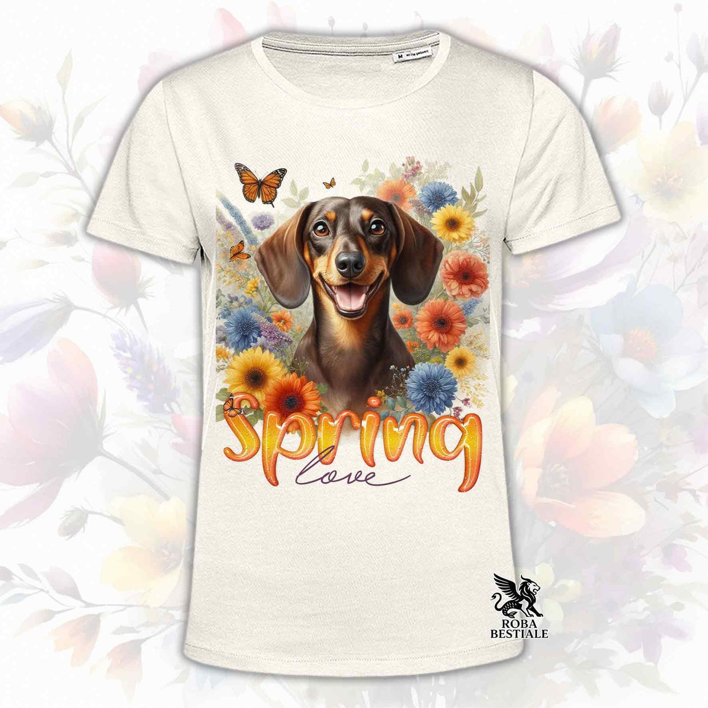 Una t-shirt beige stampata con un Bassotto a pelo corto immerso nei fiori colorati. Collezione Spring Love di Roba Bestiale