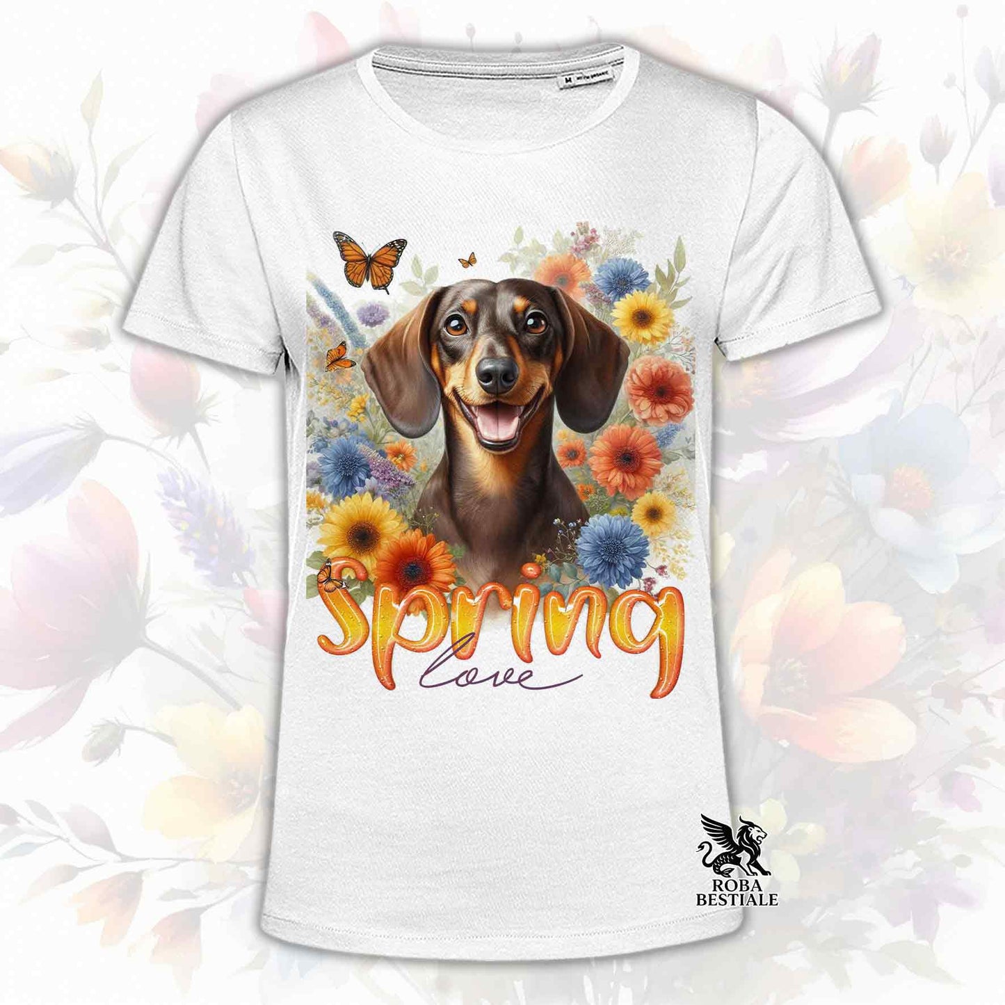 Una t-shirt bianca stampata con un Bassotto a pelo corto immerso nei fiori colorati. Collezione Spring Love di Roba Bestiale
