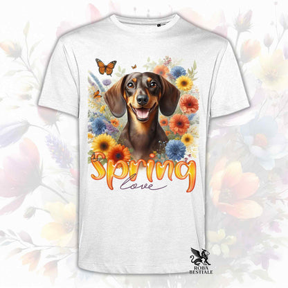 Una t-shirt bianca stampata con un Bassotto a pelo corto immerso nei fiori colorati. Collezione Spring Love di Roba Bestiale