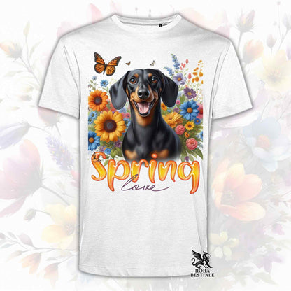 Una t-shirt bianca stampata con un Bassotto a pelo corto immerso nei fiori colorati. Collezione Spring Love di Roba Bestiale