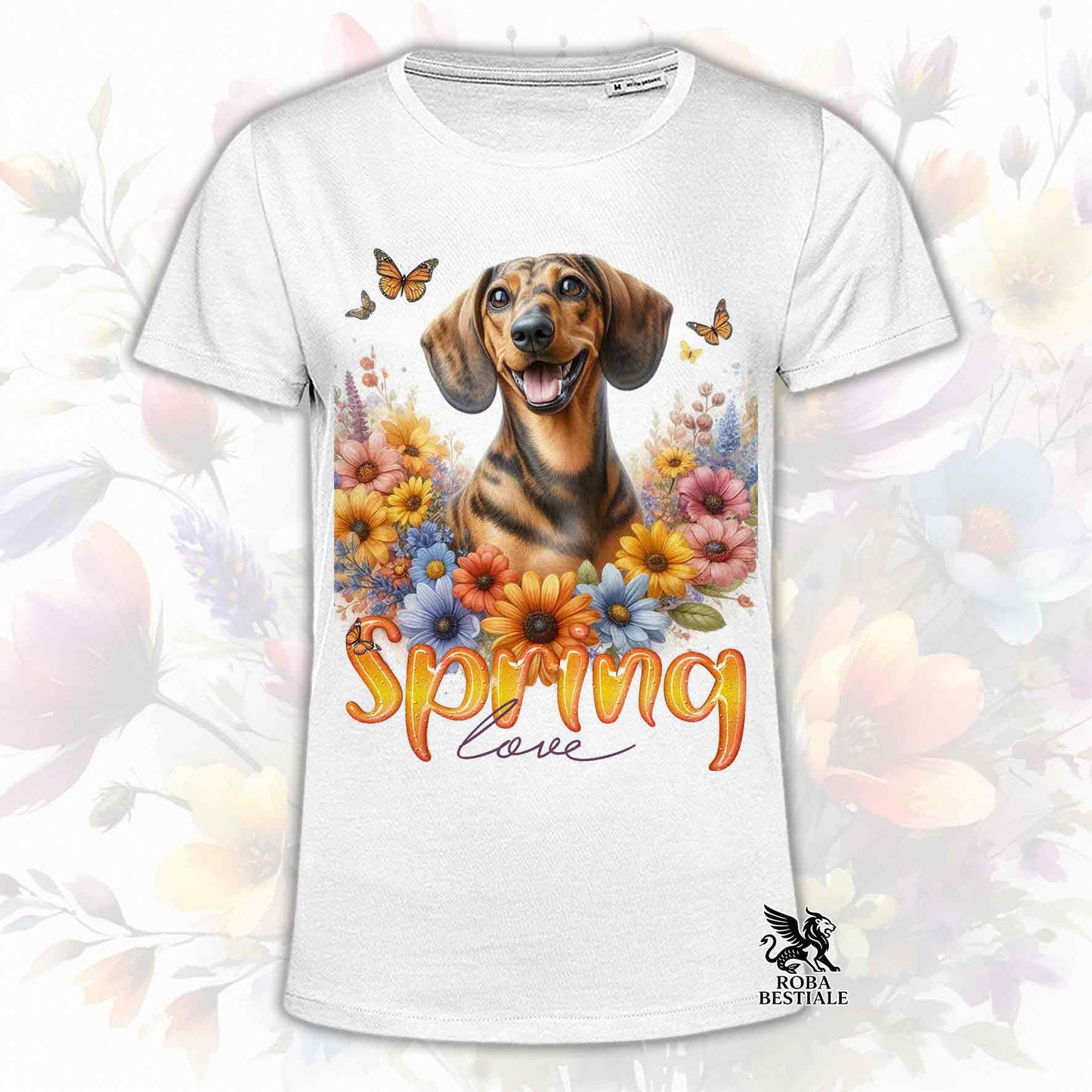 Una t-shirt bianca stampata con un Bassotto a pelo corto immerso nei fiori colorati. Collezione Spring Love di Roba Bestiale