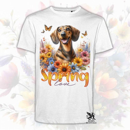 Una t-shirt bianca stampata con un Bassotto a pelo corto immerso nei fiori colorati. Collezione Spring Love di Roba Bestiale