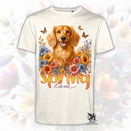 Una t-shirt beige stampata con un Bassotto a pelo lungo immerso nei fiori colorati. Collezione Spring Love di Roba Bestiale