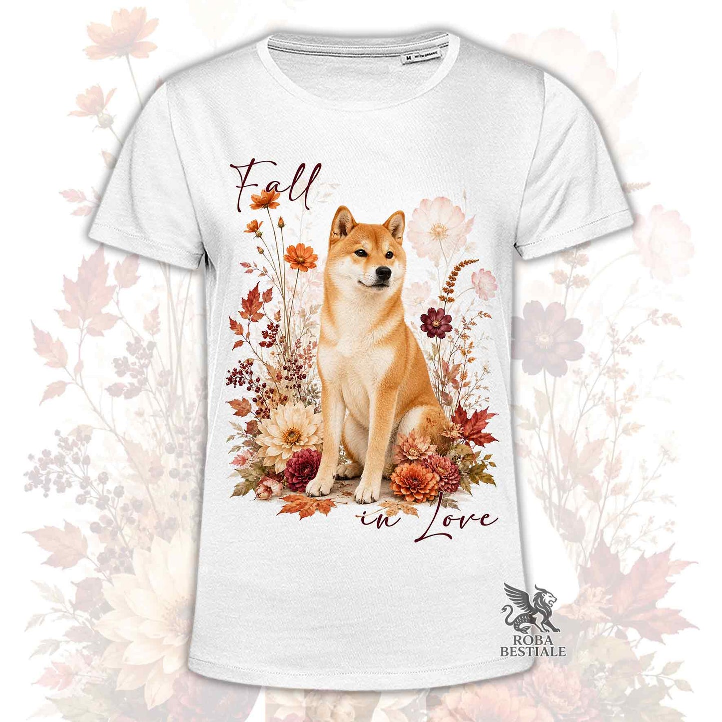 T-shirt bianca stampata con uno Shiba Inu seduto in mezzo a fiori e foglie autunnali. Grafica originale Roba Bestiale, collezione Fall in Love